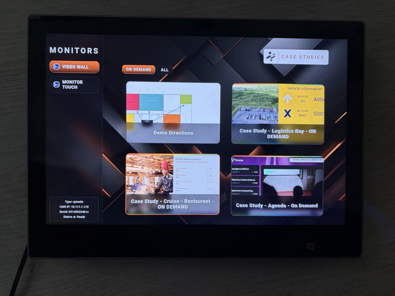 Control panel on a touch device listing the monitors it can drive, with cards that launch a different scenario on demand and a box reporting the target device status